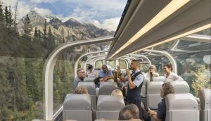 Host telling a story to guests on a train