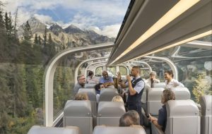 Host telling a story to guests on a train